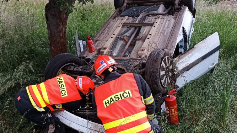 Úterní nehody pohledem hasičů: jedno auto skončilo ve křoví, druhé převrácené na střeše